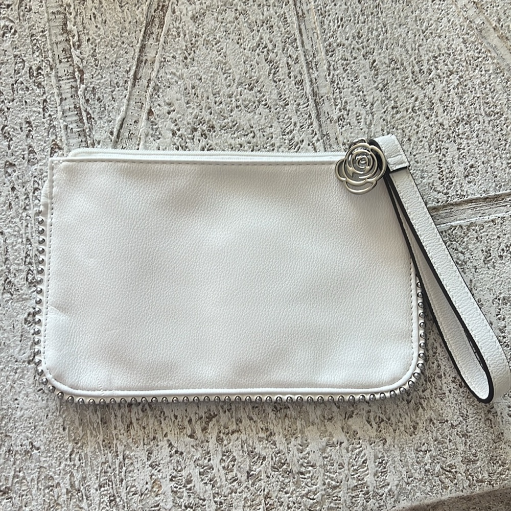 Carlos Santana White Textured Wristlet with Zipper Closure and rose medal accent